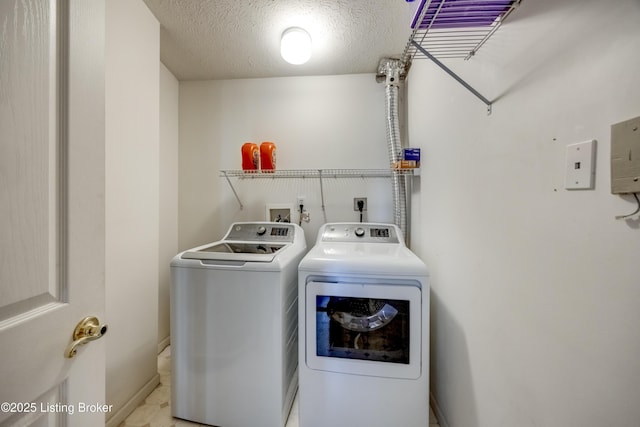 laundry area featuring washer and dryer and a textured ceiling