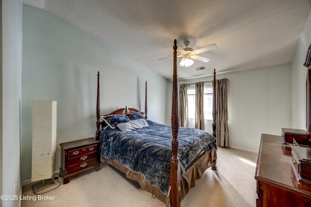 bedroom with light carpet, a textured ceiling, and ceiling fan