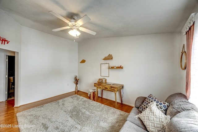 living room featuring ceiling fan and wood-type flooring