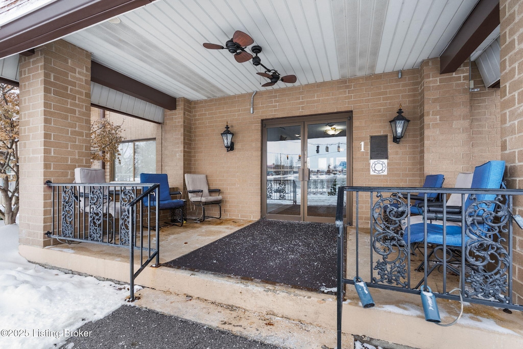 entrance to property featuring ceiling fan and a patio