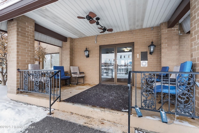 entrance to property featuring ceiling fan and a patio