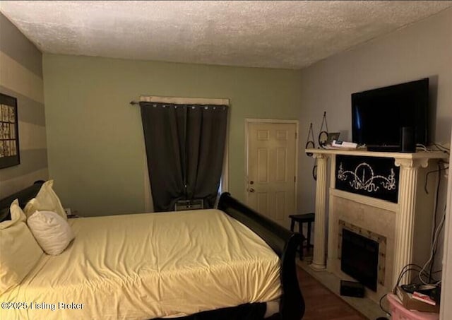 bedroom with hardwood / wood-style flooring and a textured ceiling