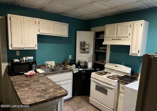 kitchen featuring white cabinets, white gas stove, and sink