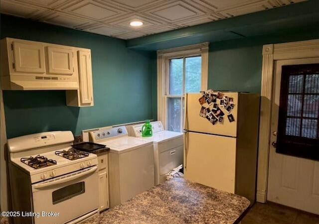 kitchen with fridge, white cabinets, washing machine and dryer, light stone counters, and white range with gas cooktop