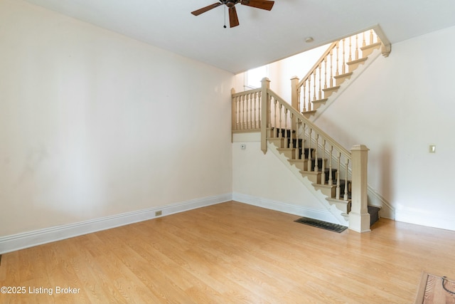 unfurnished living room with hardwood / wood-style flooring and ceiling fan