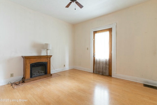 unfurnished living room with light hardwood / wood-style floors and ceiling fan