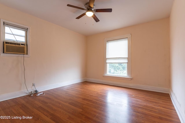 empty room with hardwood / wood-style flooring, plenty of natural light, and cooling unit