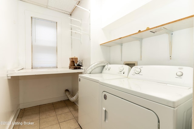 washroom with light tile patterned floors and independent washer and dryer