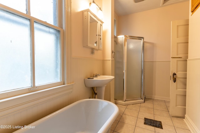 bathroom featuring tile patterned floors and separate shower and tub