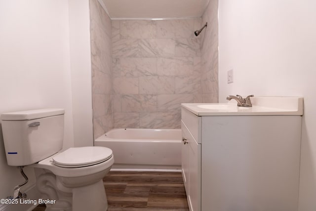 full bathroom featuring tiled shower / bath combo, hardwood / wood-style floors, toilet, and vanity