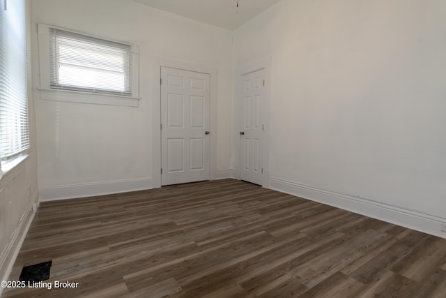 empty room featuring dark hardwood / wood-style flooring