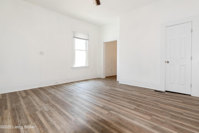 unfurnished room with wood-type flooring