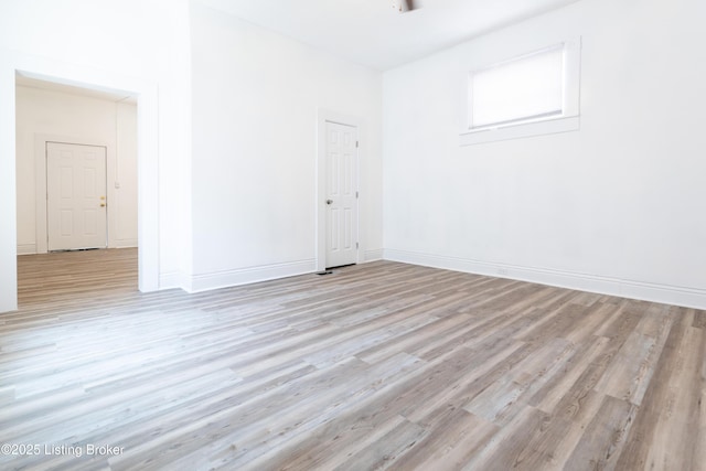 empty room with light hardwood / wood-style flooring