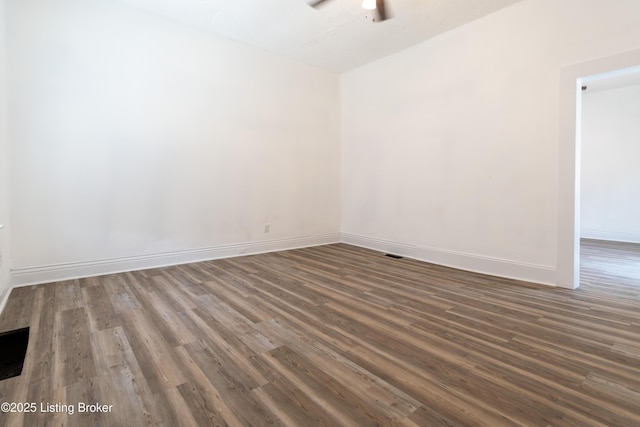 spare room featuring ceiling fan and dark hardwood / wood-style flooring