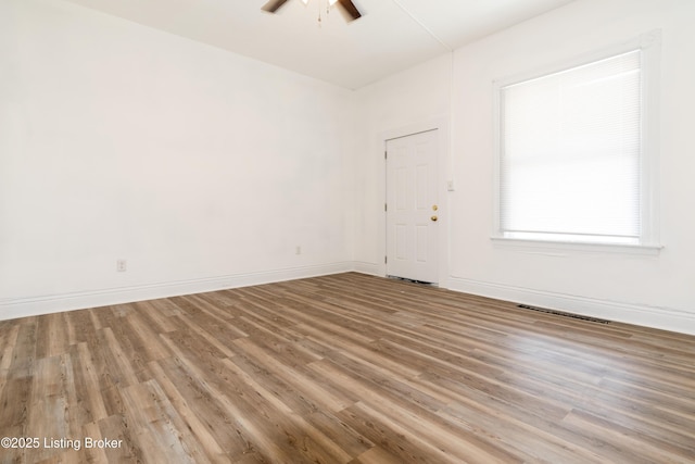 unfurnished room featuring hardwood / wood-style floors and ceiling fan