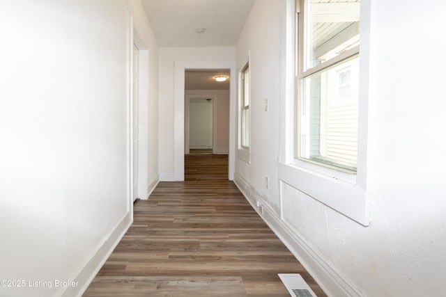 corridor with dark wood-type flooring