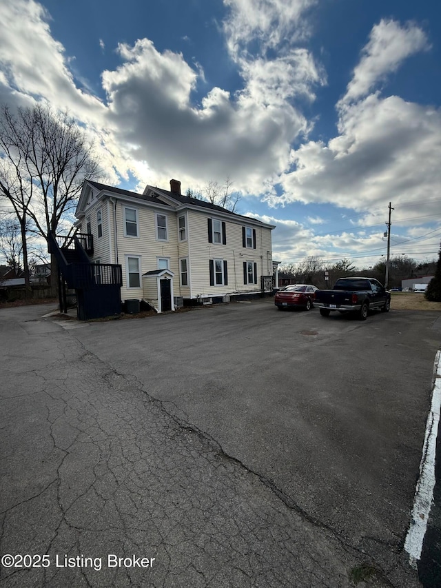 view of building exterior with uncovered parking