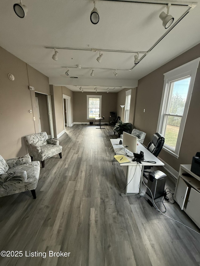 miscellaneous room featuring track lighting, wood finished floors, and baseboards