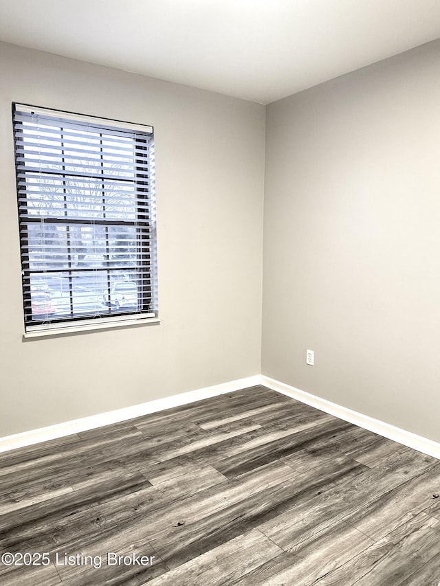 spare room with dark hardwood / wood-style floors