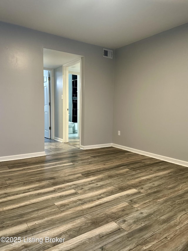 spare room with dark hardwood / wood-style floors