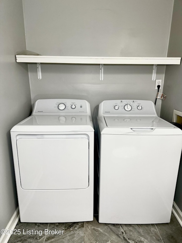 clothes washing area featuring washer and dryer