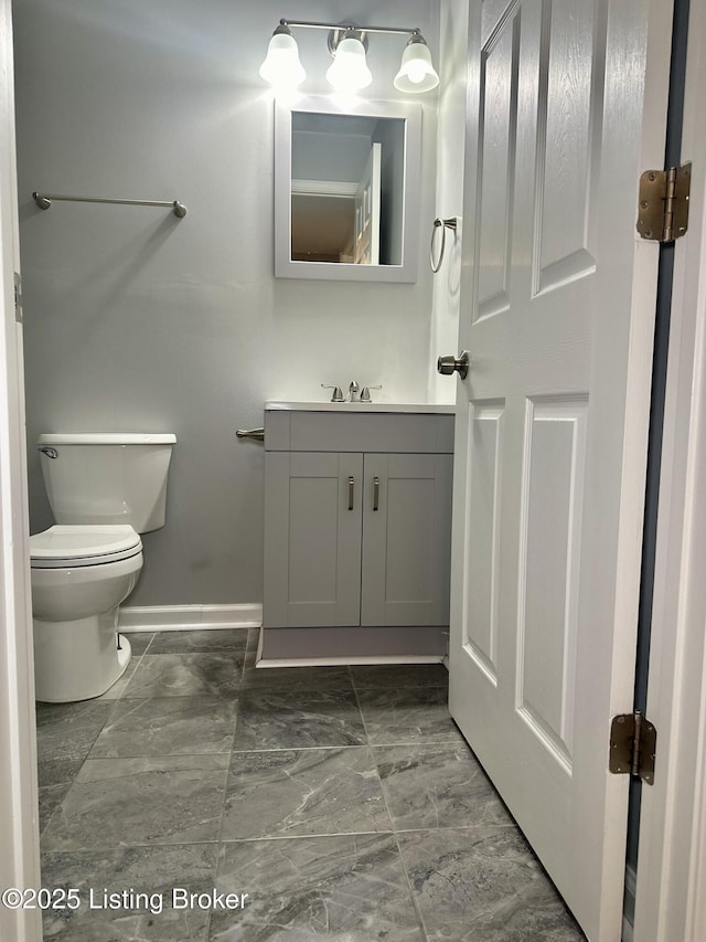 bathroom featuring toilet and vanity