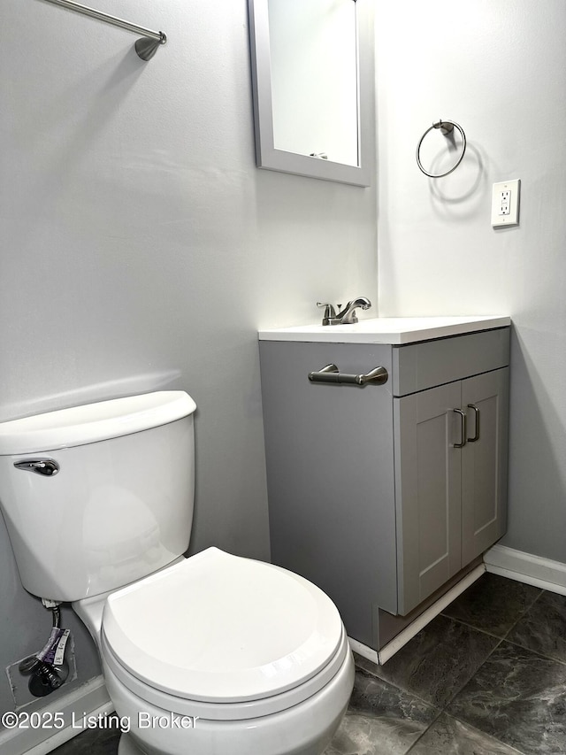 bathroom with toilet and vanity