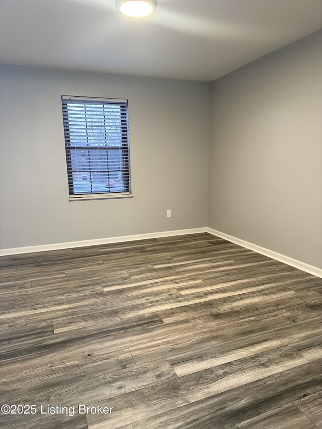 unfurnished room with dark hardwood / wood-style flooring