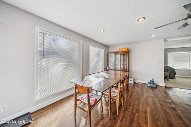 dining space featuring ceiling fan, a wealth of natural light, dark hardwood / wood-style flooring, and a textured ceiling