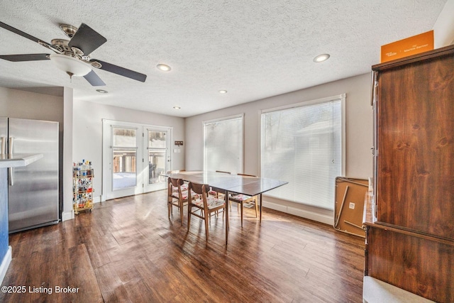 dining room featuring dark hardwood / wood-style floors and a textured ceiling