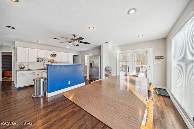 dining area featuring sink, a textured ceiling, and dark hardwood / wood-style floors