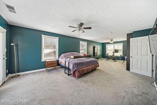 bedroom with carpet, a textured ceiling, and ceiling fan