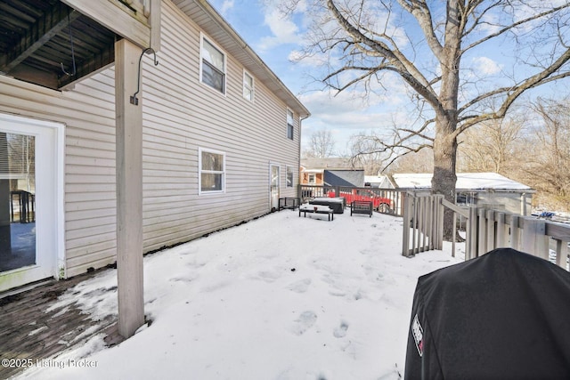 yard covered in snow with a deck