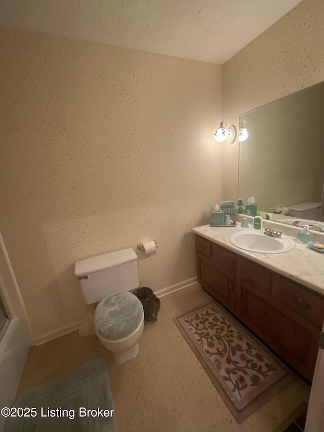 bathroom with vanity, toilet, and tile patterned flooring