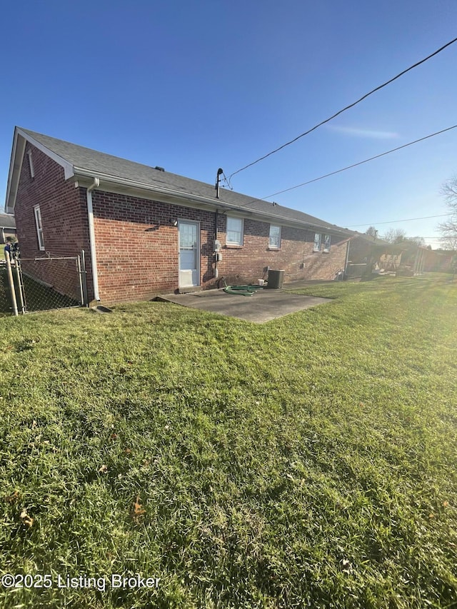 rear view of house with a yard and a patio