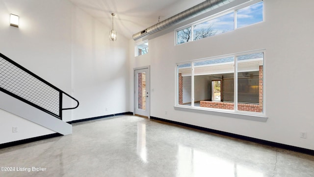 entryway with plenty of natural light and a towering ceiling