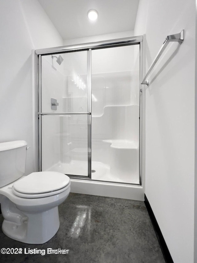 bathroom featuring toilet and an enclosed shower