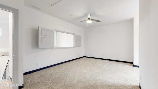 empty room featuring light carpet and ceiling fan