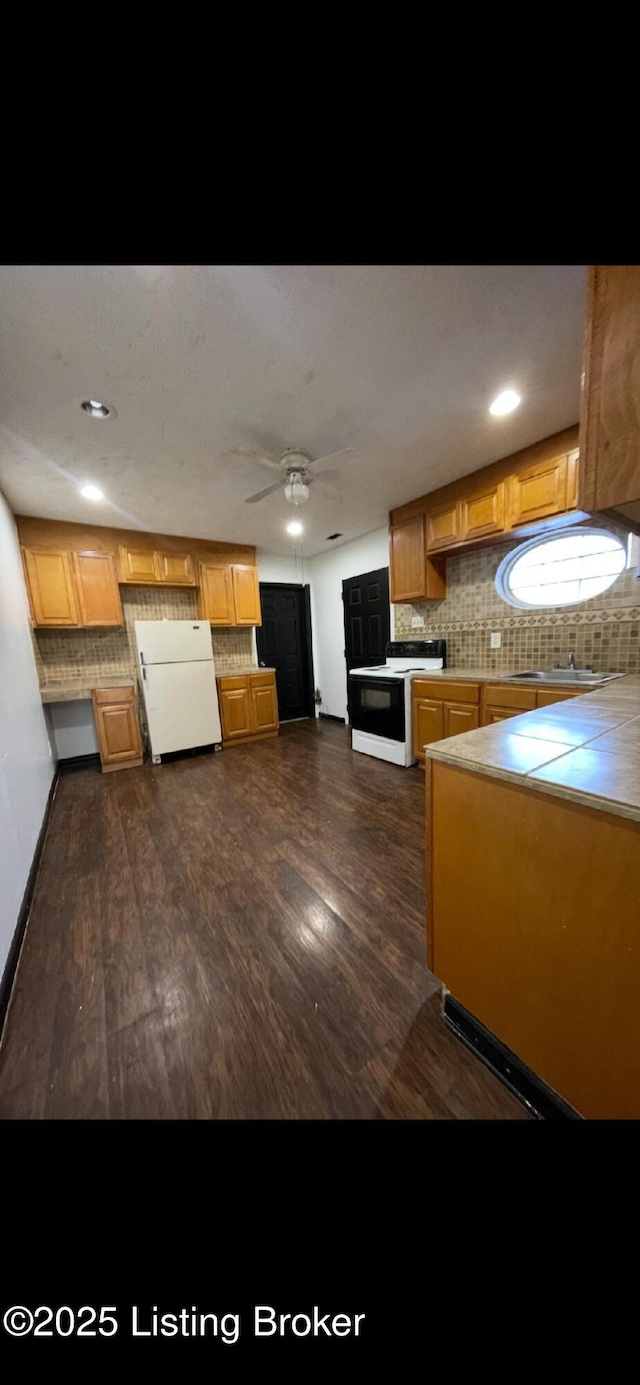 kitchen featuring ceiling fan, tasteful backsplash, dark hardwood / wood-style floors, range with electric stovetop, and white refrigerator