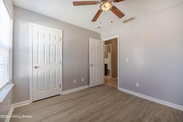 unfurnished bedroom featuring light hardwood / wood-style floors and ceiling fan