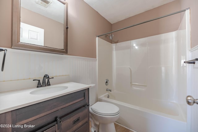 full bathroom featuring shower / bath combination, toilet, a textured ceiling, and vanity