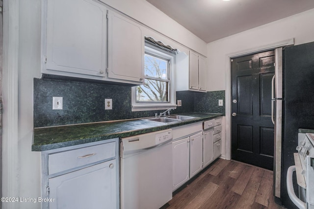 kitchen featuring white cabinetry, sink, backsplash, white dishwasher, and dark wood-type flooring