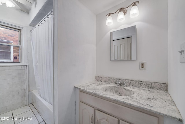 bathroom featuring shower / bath combo with shower curtain, tile patterned floors, and vanity