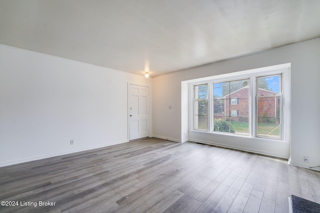 unfurnished room with hardwood / wood-style floors