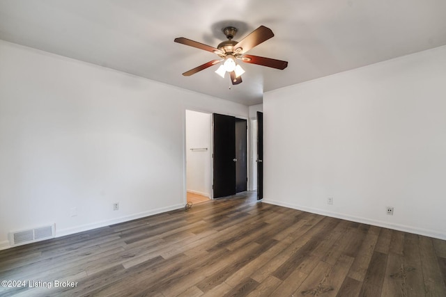 unfurnished room featuring dark hardwood / wood-style floors and ceiling fan