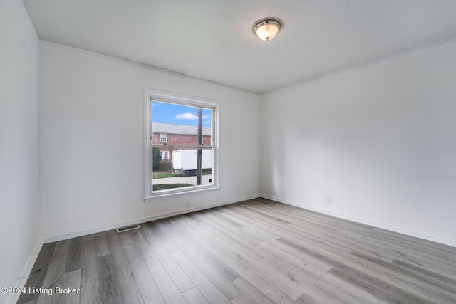 spare room featuring light wood-type flooring