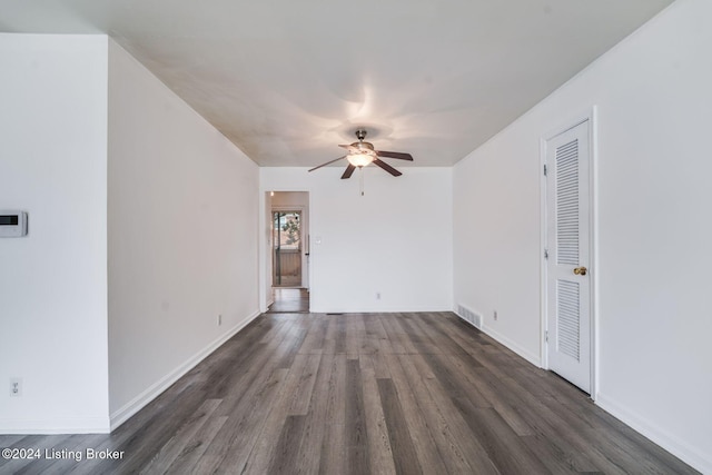 spare room with dark wood-type flooring and ceiling fan