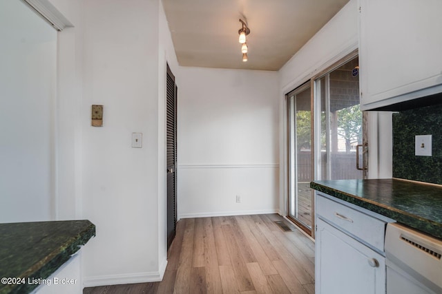 kitchen featuring dishwasher, white cabinets, backsplash, and light hardwood / wood-style flooring