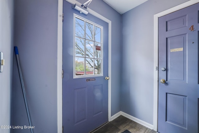 entryway featuring dark tile patterned floors