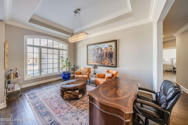 office space featuring crown molding, dark wood-type flooring, and a raised ceiling